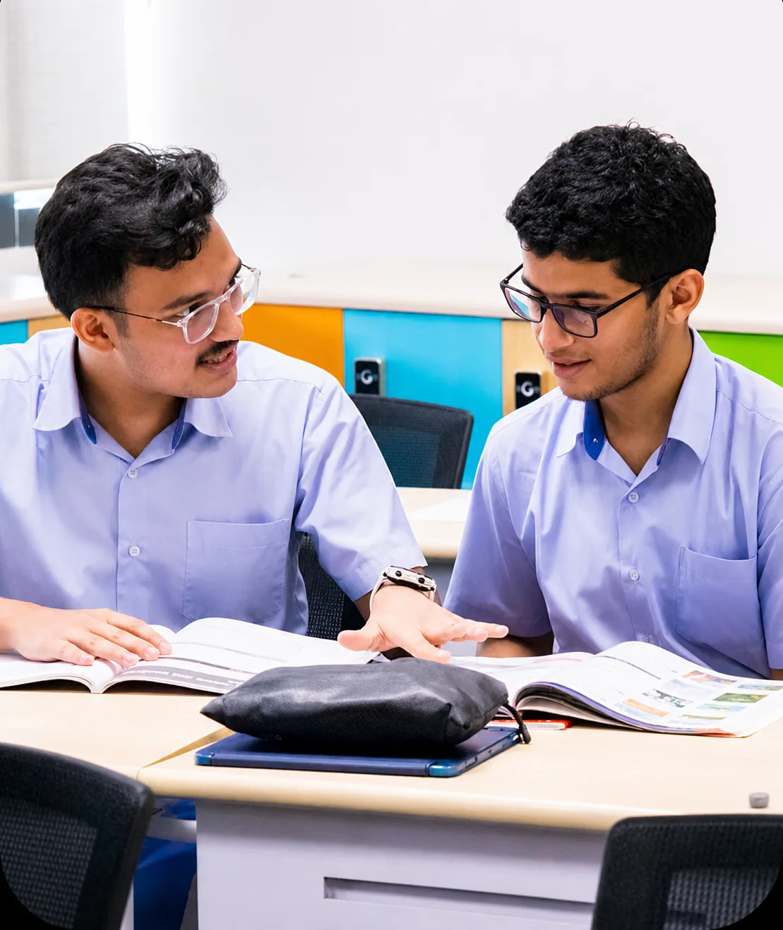Teacher and student studying together at a desk